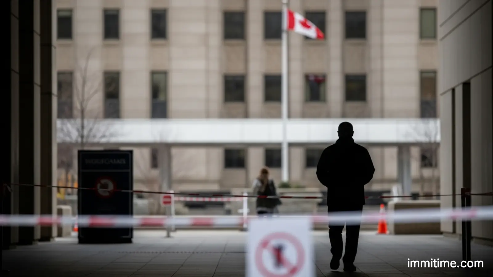 A Canadian immigration officer reviewing travel documents, representing the temporary suspension of visas for residents from affected countries.